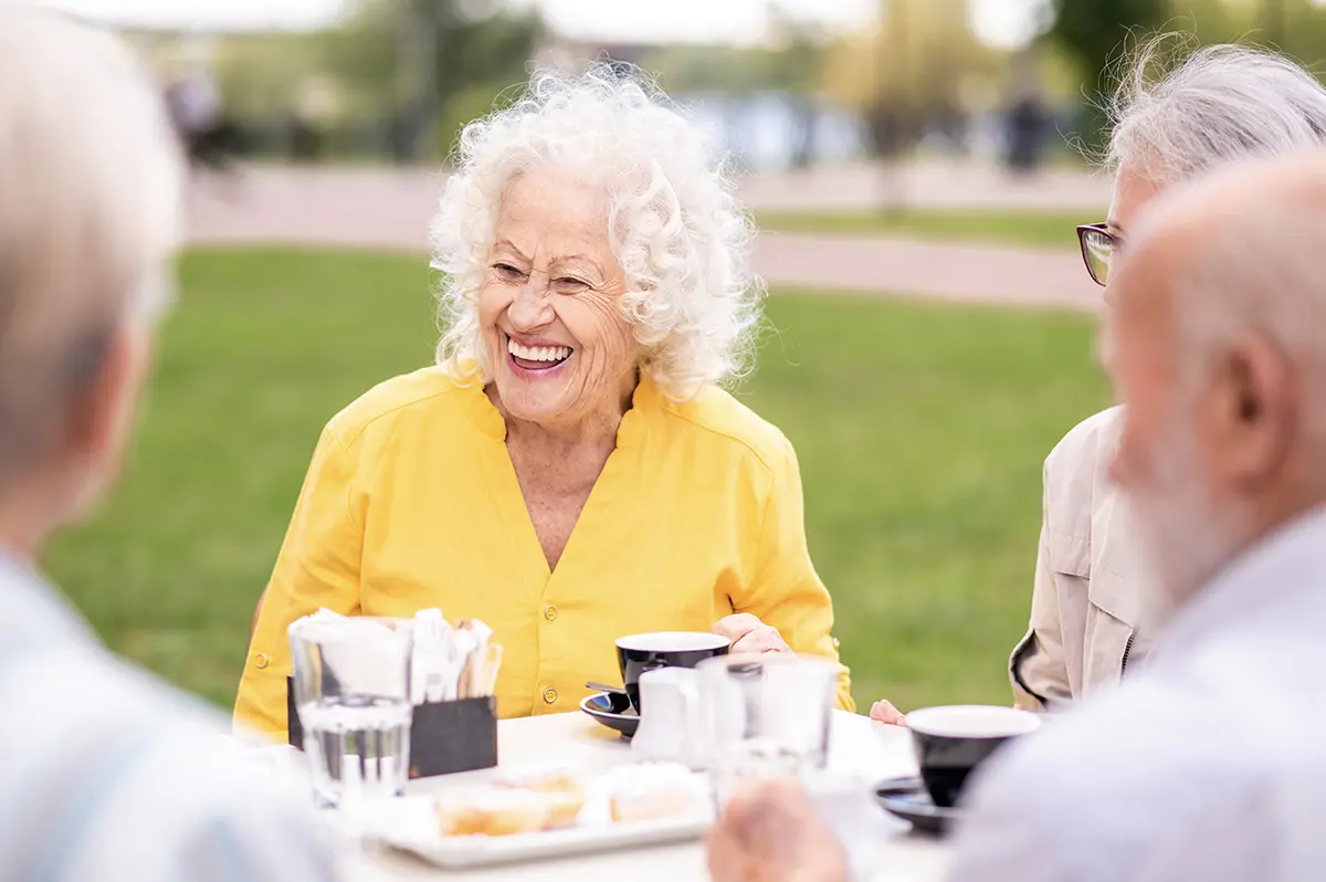 A group of senior adults eating outdoors